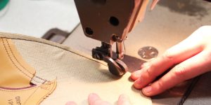 Artisan is machine stitching the sole
