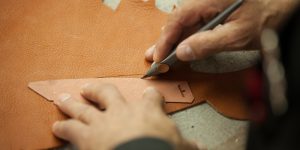 Artisan hand cutting leather