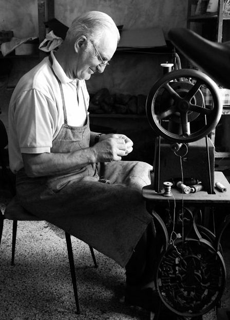 Italian shoe maker working in an italian shoe factory